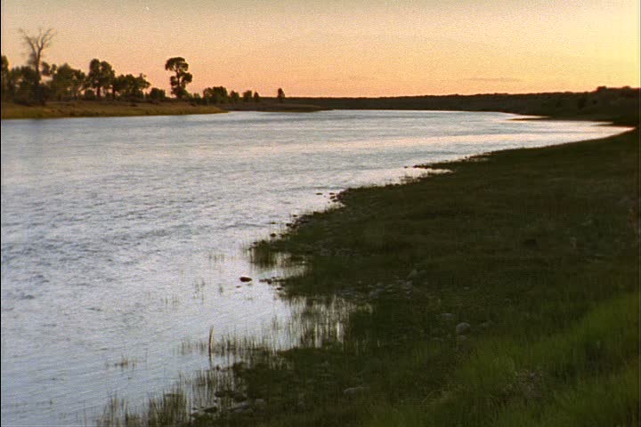 WS Missouri River running through flat, green prairie in Laramie, Wyoming.