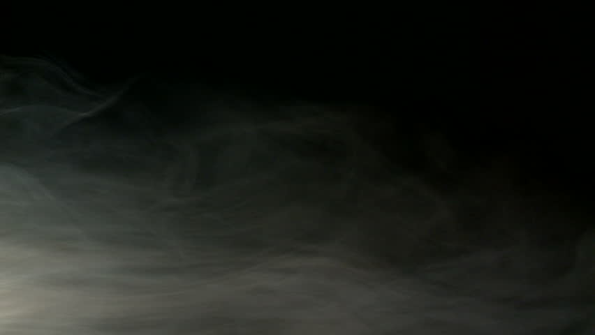 Loopable clip of low-level fog with some swirling vapors against a dark