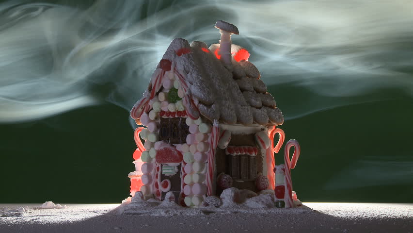 Loopable clip of a gingerbread house surrounded by fog.