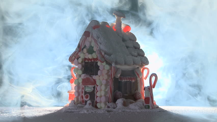 Loopable clip of a gingerbread house surrounded by smoke.