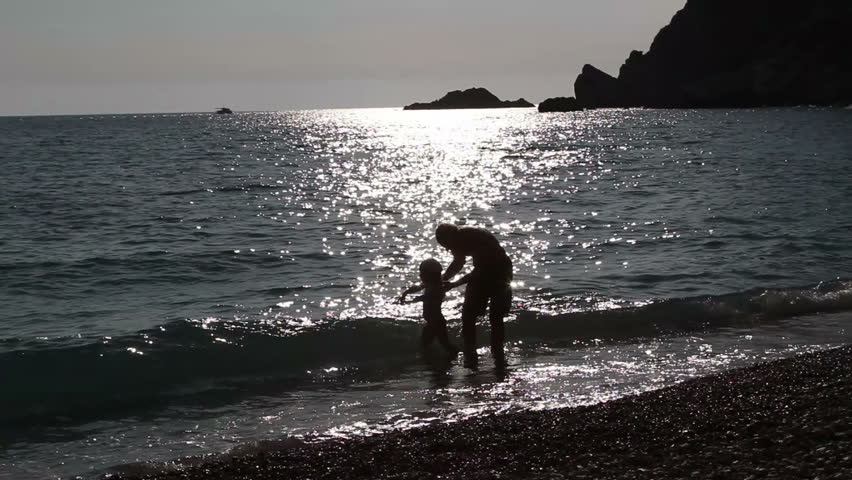 father plays with the small daughter of the sea, Adriatic Sea, Montenegro