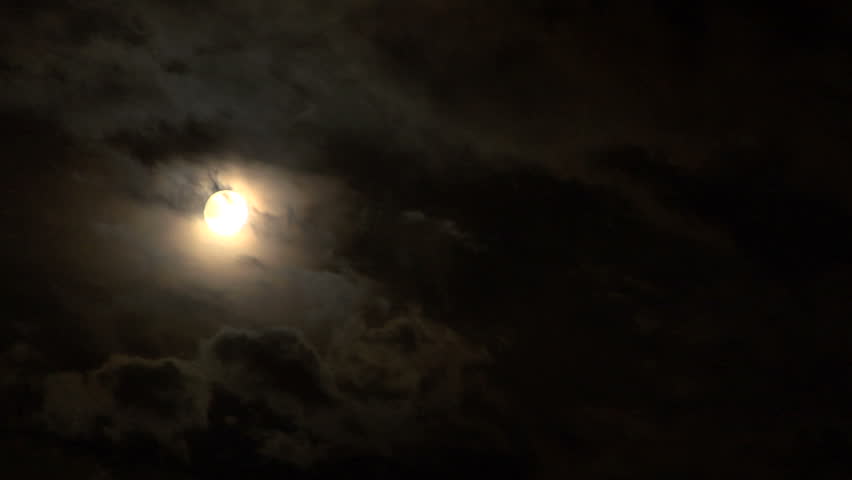 Full glowing moon on cloudy foggy night sky time lapse