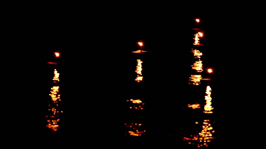 late spark candles waving with nice reflection on ocean water surface. time