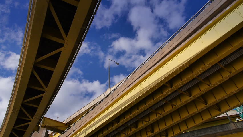 Looking up at the steel beams and girders of the Fort Duquesne Bridge over the