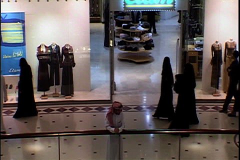 RIYADH, SAUDI ARABIA - SEPTEMBER 25, 2002: Overhead shot of women in black hijab walking through mall.