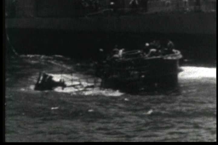 1950s - The U.S.S. Guadalcanal tows a German U boat on the high seas during World War Two.