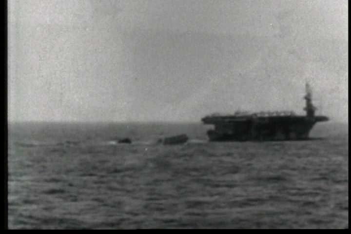 1950s - The U.S.S. Guadalcanal tows a German U boat on the high seas during World War Two.