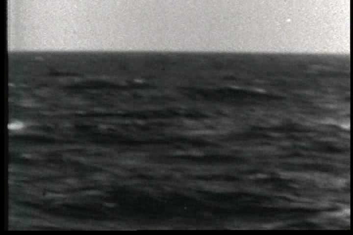 1950s - The U.S.S. Guadalcanal prepares to capture a German submarine in World War Two.