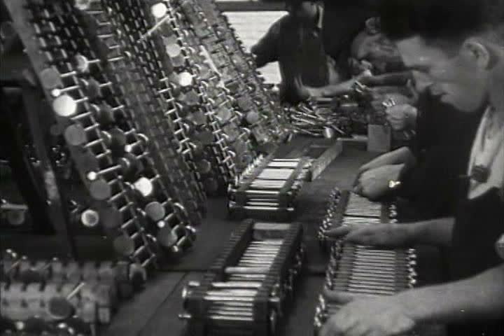 1930s - Men do very specialized work in a factory by hand in 1931.
