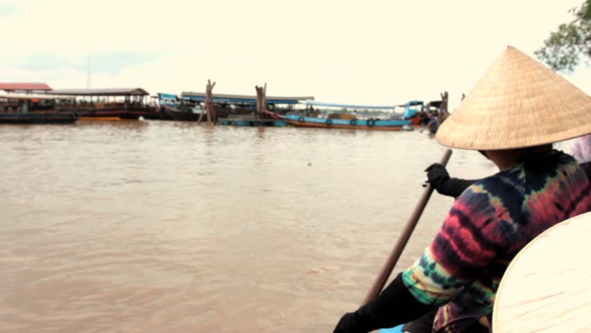 MEKONG DELTA, VIETNAM - JULY 24: woman rows a boat on a canal, Vietnam on July