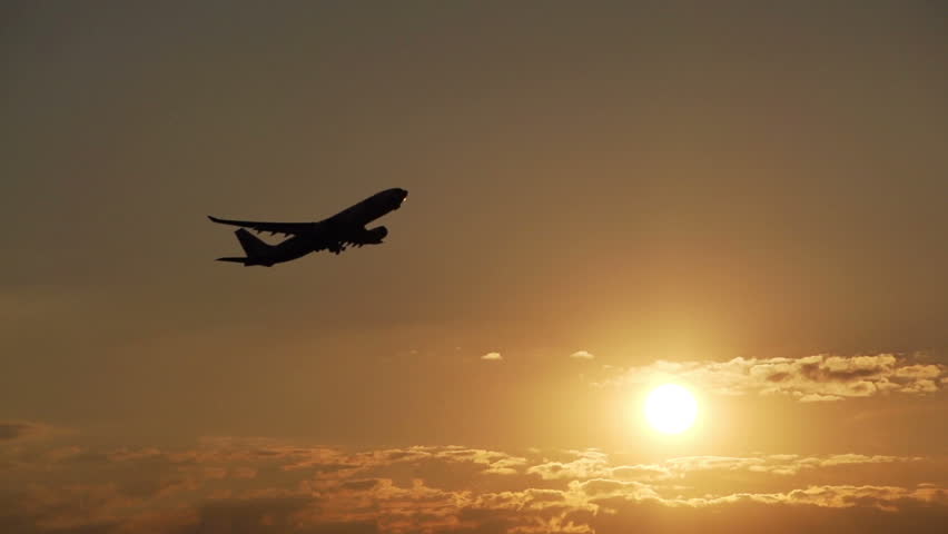 Airplane take off at sunset