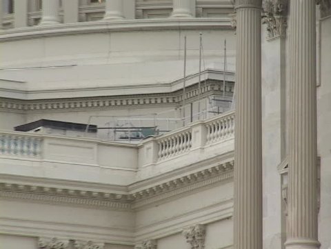 US Capitol building with flag flying; close up zooms out and then in again.