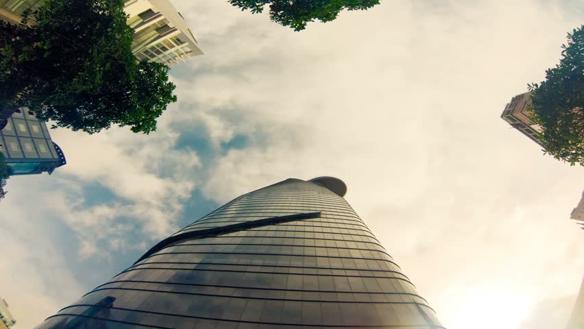 Skyscrapers rise to dizzying heights as clouds pass overhead in this low-angle