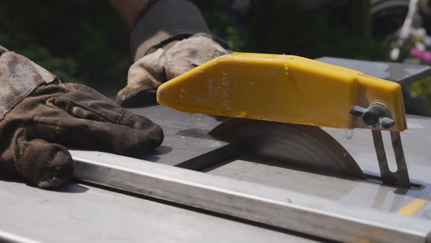 Circular saw is spinning at high speed to cut through stone tiles