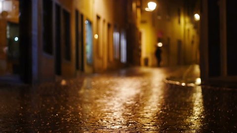 Rainy night in Bassano del Grappa, old traditional town in Italy. Establishing shot.