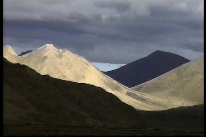 Peaks of the Himalayas in shadowy sun in Shegar, Tibet.