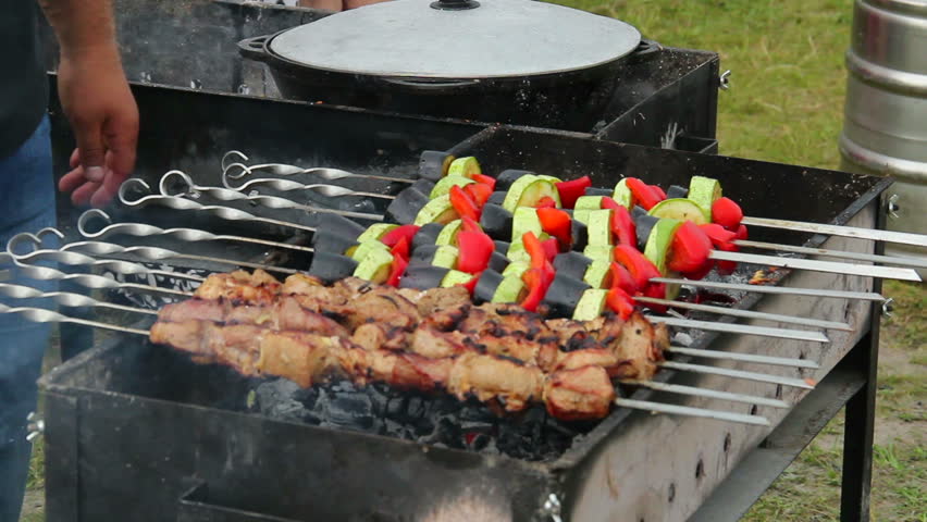 Roasting preparing outdoor kebab barbecue vegetables on brazier