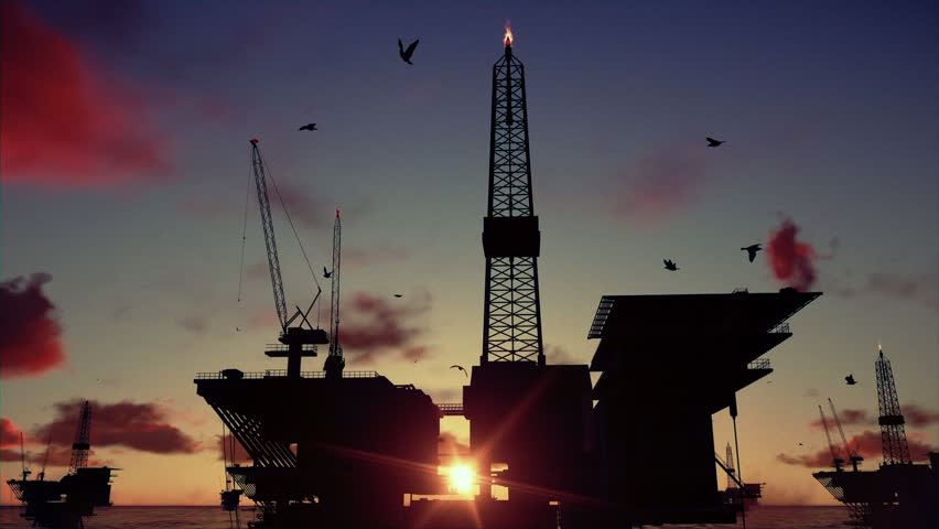 Oil rigs in ocean at sunrise, timelapse
