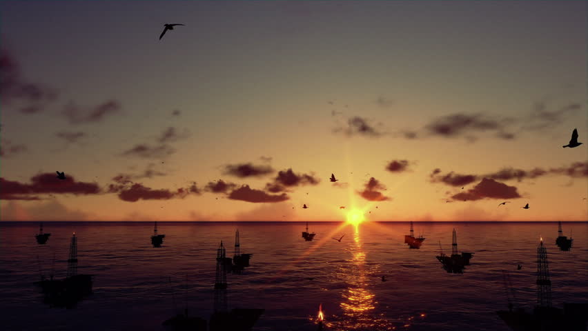 Oil rigs in ocean, time lapse sunrise, camera tilt