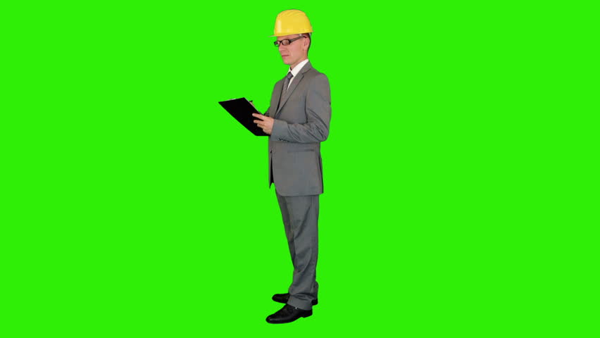 Young architect taking notes on a clipboard, Green Screen