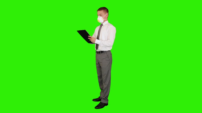 Young businessman, protective glasses and mask taking notes, Green Screen