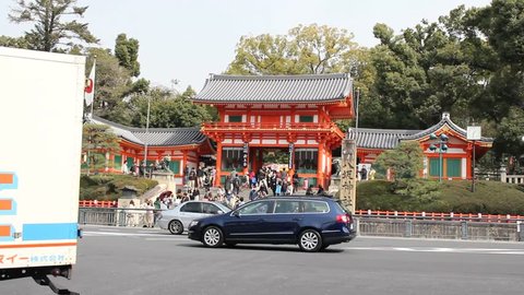 KYOTO - CIRCA 2013: Cars at intersection near Japanese Shinto shrine in Kyoto, Japan.