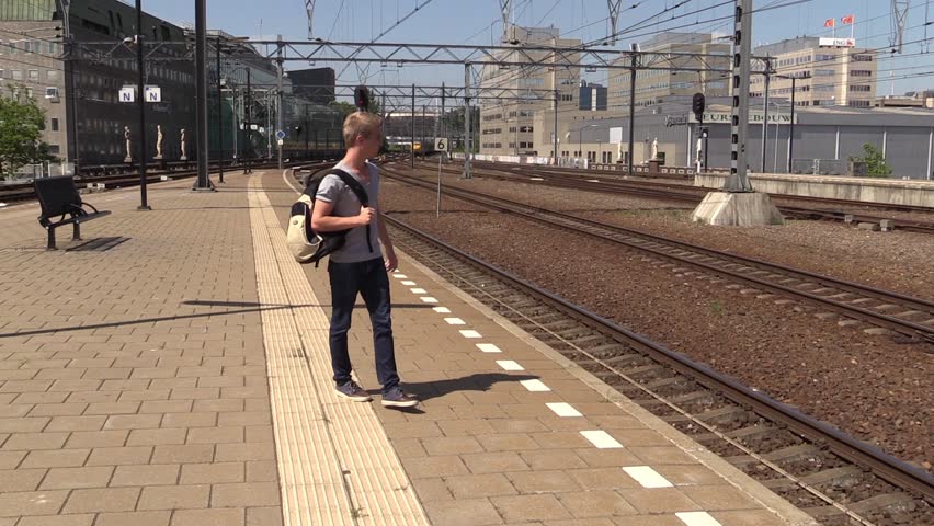 Impatient student waiting for train, steadicam shot
