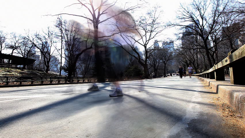 Time lapse of joggers on a sunny day in Central Park Manhattan, New York City /