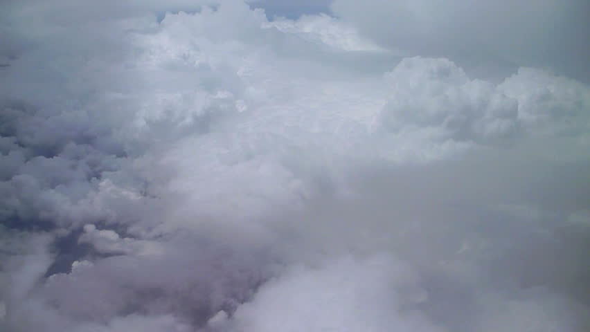 Cloudscape aerial while flying above storm clouds.