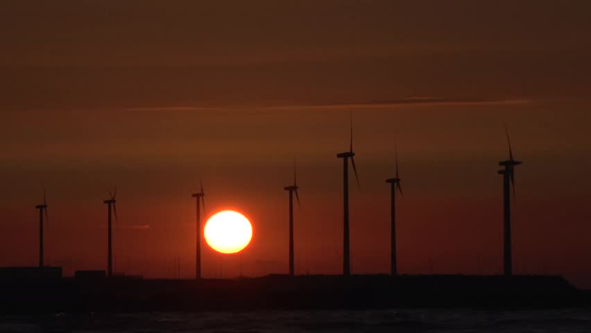 Sunset timelapse with windmills at sea