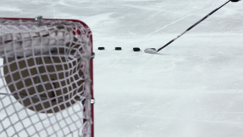 Hockey player shoots several pucks to targets in gate, closeup Royalty-Free Stock Footage #4421696