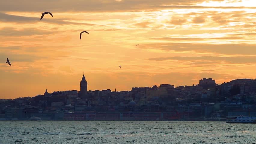 Sunset in Istanbul. Galata Tower in distance with the city silhouette. 
