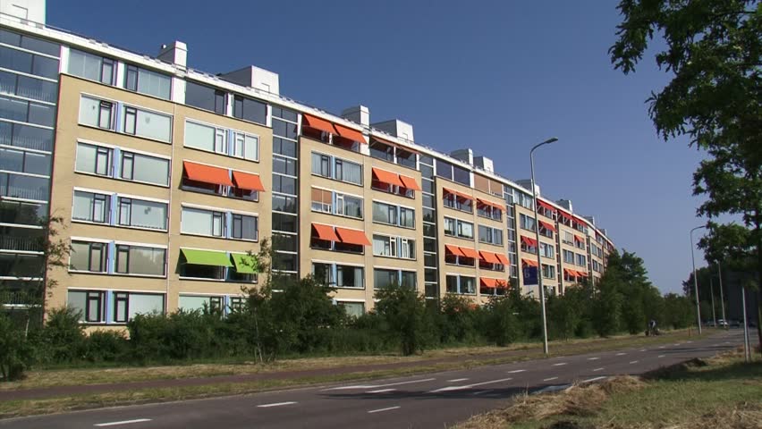 KIJKDUIN, THE NETHERLANDS - JULY 2013: Large round apartment building at street corner, designed in the 1960s to protect the village lying behind against sea wind, known popularly as Chinese Wall.