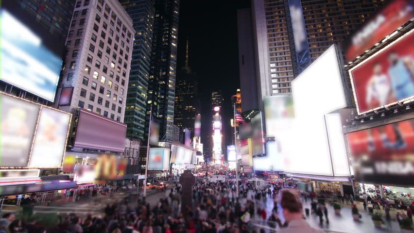 Time lapse of bustling crowds and traffic and the famous advertising billboards at Times Square, New York.