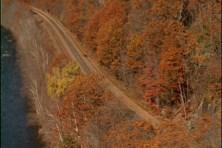 Freight train moves past the woods along the Deerfield River in North Adams, Massachusetts.