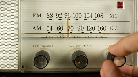 close up of a vintage radio dial with the stations and frequencies being tuned
