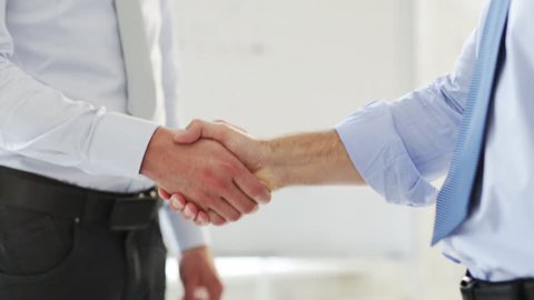 business handshake - two businessmen shaking their hands