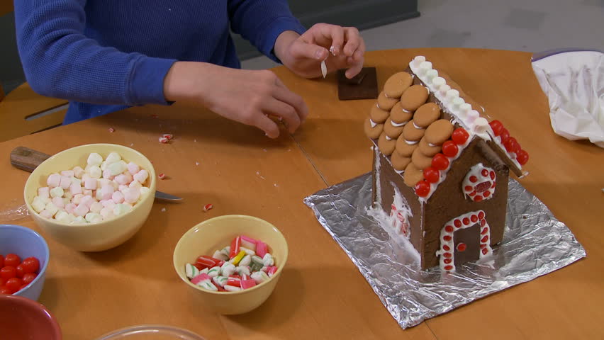 Finishing a gingerbread house.