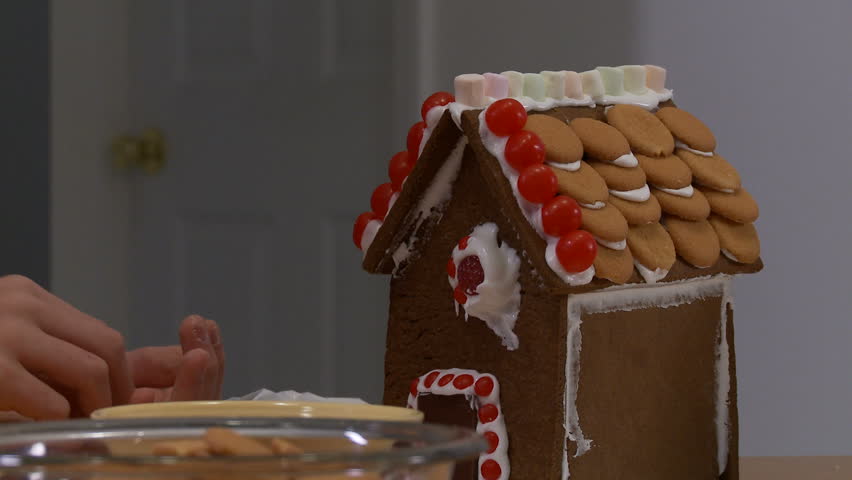 Decorating a gingerbread house.