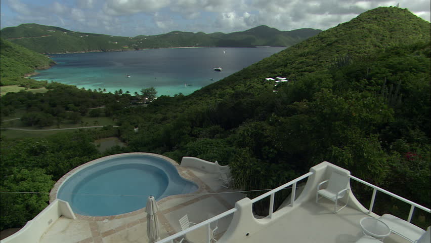 View of boats in a tropical harbor from a luxury vacation villa in the hills