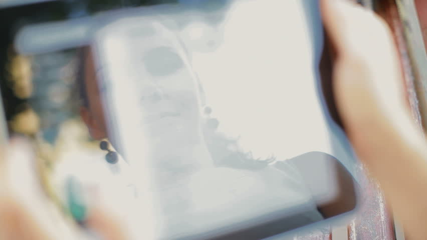 young business woman working on the tablet. Her face reflected on the screen.