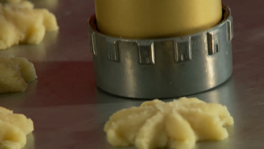 Stamping out star-shaped holiday cookies with a cookie cutter.