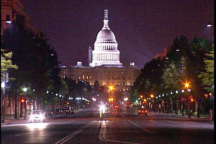 WASHINGTON, D.C. - MAY 29, 2002: MS of traffic on Pennsylvania Avenue with brightly lit United States Capitol in the background.