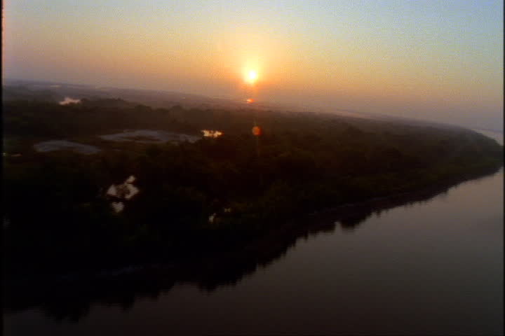 Sunset aerial over marshes, lowlands and lower Mississippi River.