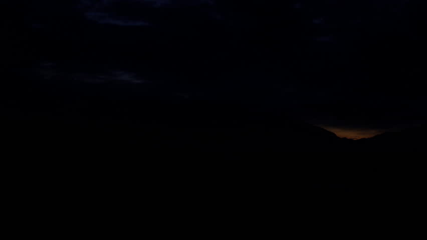 High definition time lapse of a tone mapped sunrise over the mountains.