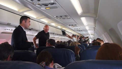 US AIRWAYS INTERIOR FLIGHT - CIRCA 2013:Interior airplane, point of view as passenger from coach seats as travelers depart plane.