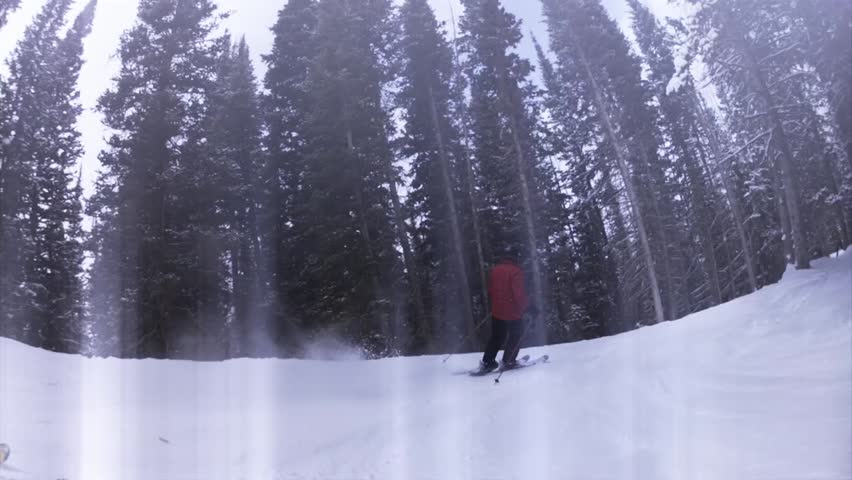 Downhill skiing at a beautiful mountain ski resort after a fresh snowfall