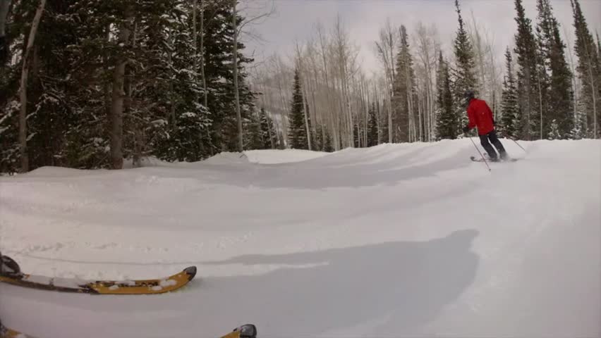 Downhill skiing at a beautiful mountain ski resort after a fresh snowfall