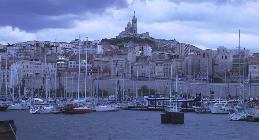 Scenic view of a castle on a hilltop above a marina in Marseilles, France