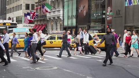 NEW YORK, NY - JULY 8: NYC pedestrians crossing street in slow motion on July 8, 2013 in New York, New York.
